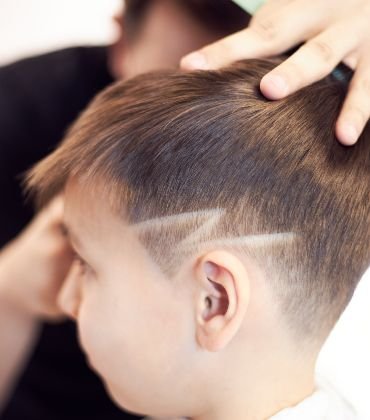 httpselements.envato.combarber man cuts the hair of a little handsome boy FLPMWQ4.jpg