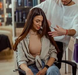 httpselements.envato.comyoung woman gets haircut with scissors at beauty s BXPDNVG.jpg